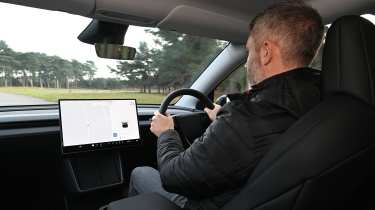 Auto Express deputy editor Richard Ingram driving the Tesla Model Y