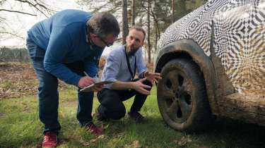 John McIlroy and Philippe Turchet inspecting the Dacia Duster&#039;s front wheel