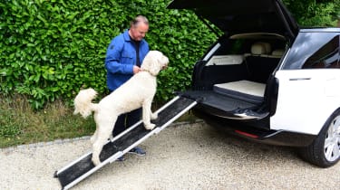 Auto Express editor-in-chief Steve Fowler loading his dog into a Range Rover via a ramp