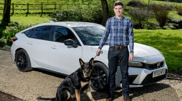 Tristan Shale-Hester and his dog standing in front of the Honda Civic Sport