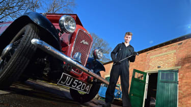 Student next to classic car