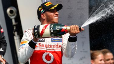 Lewis Hamilton celebrates on the podium