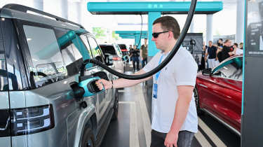Auto Express senior content editor Shane Wilkinson charging a BYD Ti7 with a Flash Charger