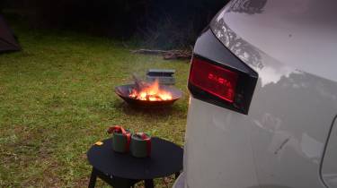 Dacia Duster parked next to a firepit