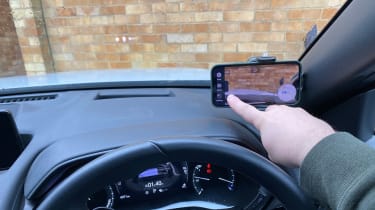 Mobile phone in windscreen cradle with dashcam app setup