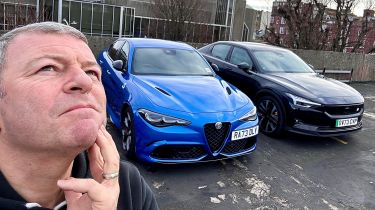 Steve Sutcliffe standing next to an Alfa Romeo Giulia Quadrifoglio and Polestar 2