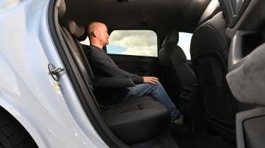 Audi S6 Avant e-tron - rear interior, car being sat in by Auto Express chief reviewer Alex Ingram