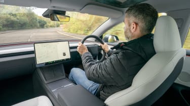 Auto Express deputy editor Richard Ingram driving the new Tesla Model 3 in the UK