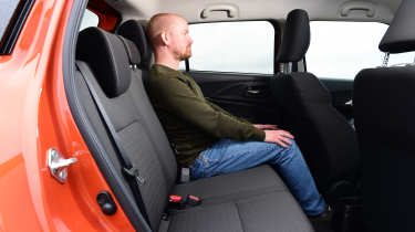 Auto Express chief reviewer Alex Ingram sitting in the Suzuki Swift&#039;s back seat