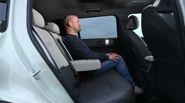 Auto Express chief reviewer Alex Ingram sitting in the Kia EV3&#039;s back seat