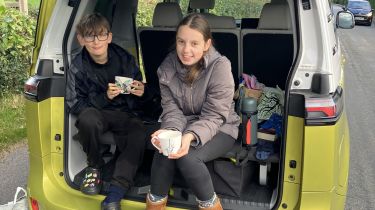 Paul Barkers children changing their muddy boots in the back of the Volkswagen ID.Buzz after a hike