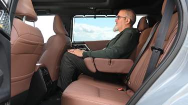 Auto Express senior road test editor Dean Gibson sitting in the Mitsubishi Outlander's rear seat