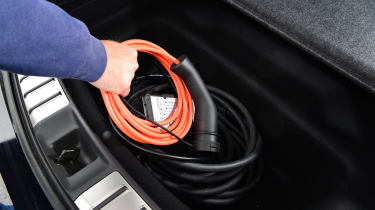 Auto Express creative director Darren Wilson removing charging cables from the Lexus RZ&#039;s boot