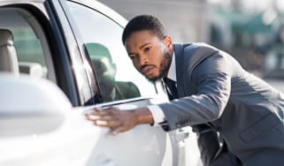 Man checking car in dealership