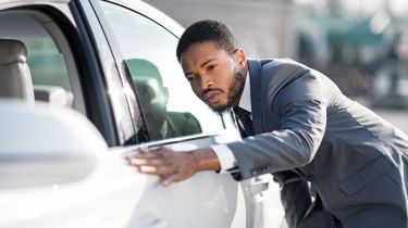 Man checking car in dealership