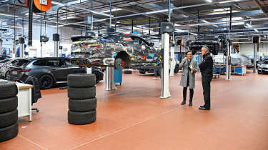 Auto Express consumer reporter Tom Jervis standing in a BMW M division workshop