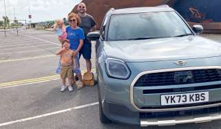 Auto Express creative director Darren Wilson standing with his family next the MINI Countryman