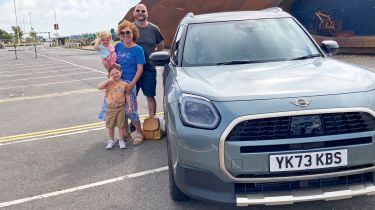 Auto Express creative director Darren Wilson standing with his family next the MINI Countryman