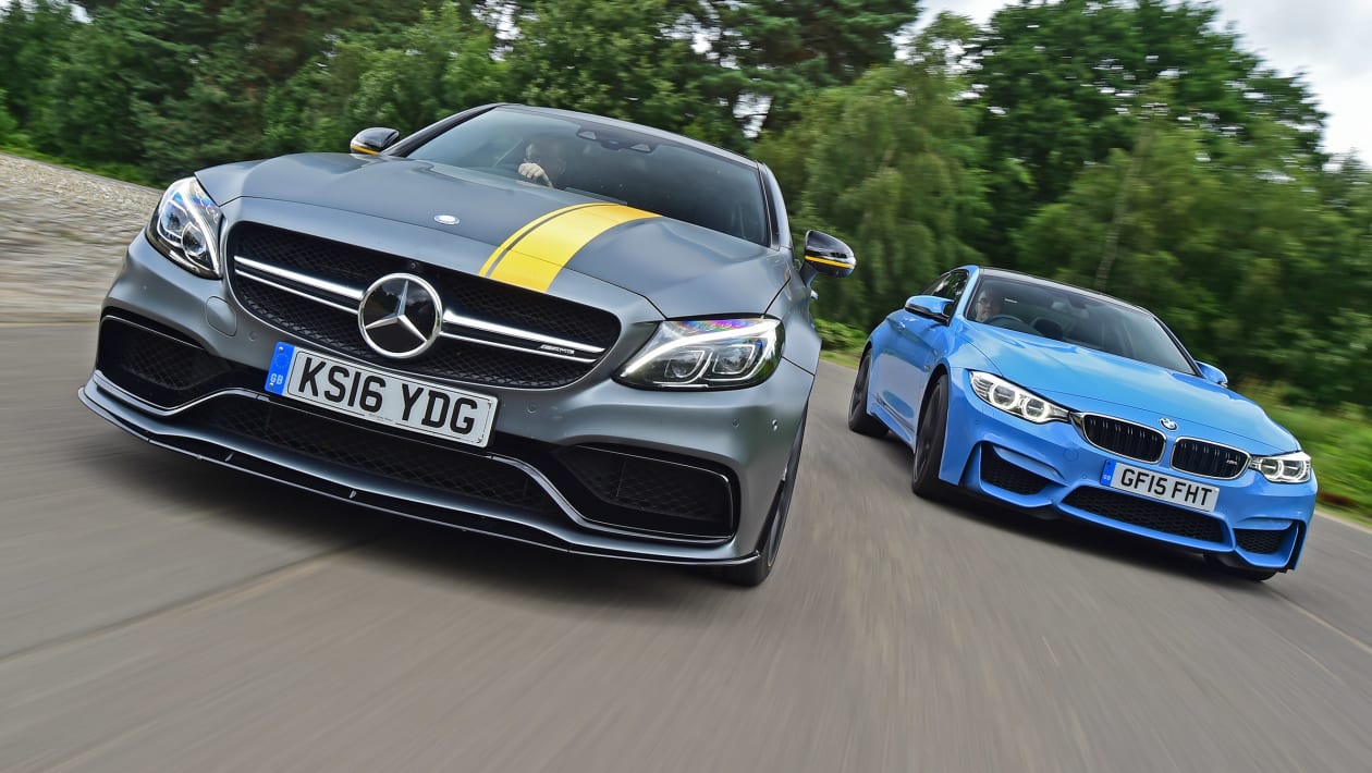 Close-up of the BMW M4 and Mercedes-AMG GT 63 rear ends showing dual exhausts