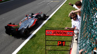 Jenson Button crosses the finishing line