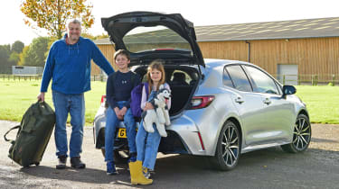 Auto Express features editor Chris Rosamond and his family standing behind the Toyota Corolla