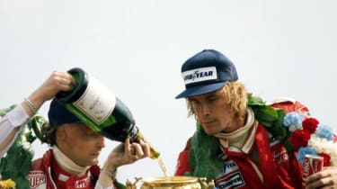 Second-place Niki Lauda and winner James Hunt on the podium at the 1977 British Grand Prix