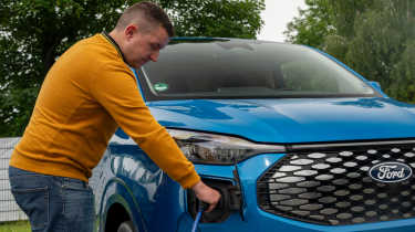 Auto Express senior content editor Shane Wilkinson plugging in the Ford E-Transit Custom