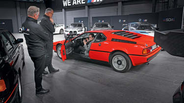 Auto Express consumer reporter Tom Jervis sitting in a BMW M1
