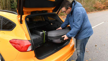 Ford Focus ST Estate: long-term test review - first report - John loading luggage in boot