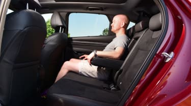 Auto Express chief reviewer Alex Ingram sitting in back seat of Hyundai Tucson Hybrid