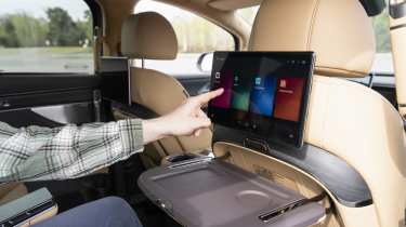 New Denza D9 - Auto Express senior news reporter Alastair Crooks using the rear infotainment screen
