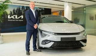 Kia&#039;s UK boss, Paul Philpott standing next to a Kia EV6