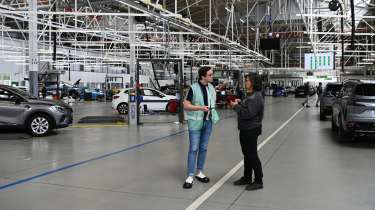 Auto Express consumer reporter Tom Jervis standing inside the Renault ReFactory facility