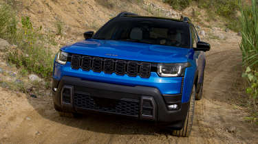 New Jeep Cherokee - blue front climbing up a dirt track