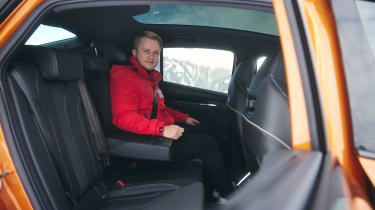 Jonas Uhlig sitting in the back of the Skoda Enyaq Coupe vRS