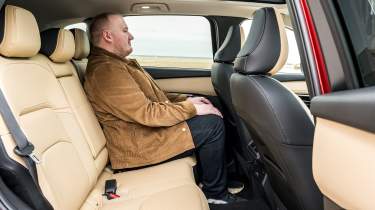 Auto Express news reporter Ellis Hyde sitting in the Mazda CX-5's rear seat