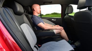 Auto Express chief reviewer Alex Ingram testing the back seats of the facelifted Volkswagen ID.3