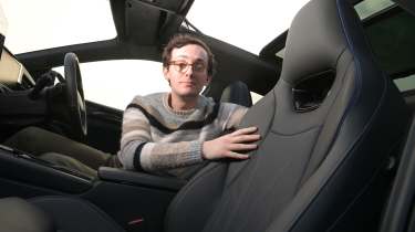 Auto Express consumer editor Tom Jervis touching a Volkswagen Passat's seat