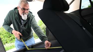 Auto Express senior test editor Dean Gibson measuring the MG4 Urban's boot
