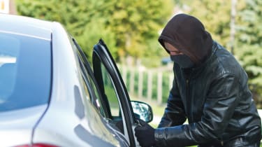 Thief breaking into car