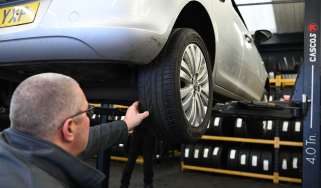 Protyre area manager Simon Hall inspecting a Vauxhall Corsa's tyre