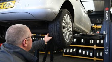 Protyre area manager Simon Hall inspecting a Vauxhall Corsa's tyre