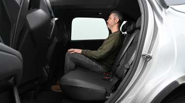 Auto Express deputy editor Richard Ingram sitting in the BMW iX3's rear seat