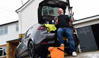 Auto Express contributor Tom Barnard sitting in the Mazda 3&#039;s boot