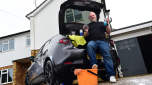 Auto Express contributor Tom Barnard sitting in the Mazda 3&#039;s boot