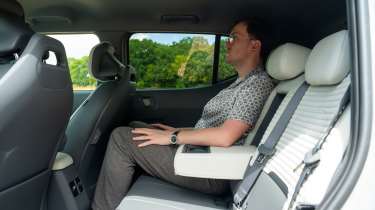 Kia EV2 Long Range - rear interior, back seats being sat in by Auto Express consumer reporter Tom Jervis 