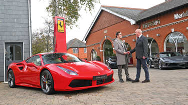 How to buy a used supercar - shaking hands in front of dealership