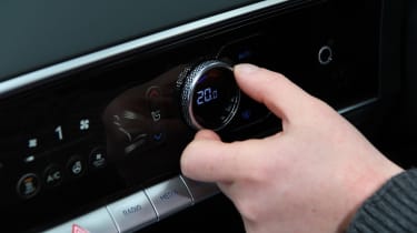 Auto Express chief reviewer Alex Ingram operating Genesis Electrified GV70&#039;s climate controls