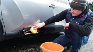 Auto Express executive editor Paul Adam washing the Citroen C4 X&#039;s wheel