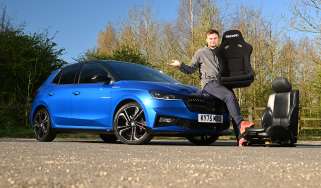 Skoda Fabia 130 long-term test - Senior news reporter Alastair Crooks sat on the bonnet of the Skoda holding a racing car seat